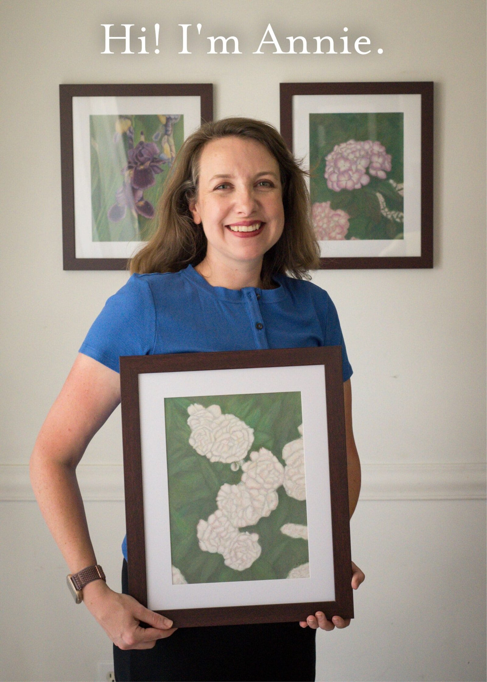 Annie - Intro Photo woman smiling and holding pastel painting of peonies on green background